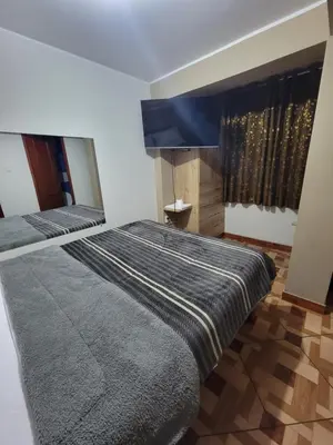 a bedroom with two beds and a window at LUJO HOGAR - Cerca a Plaza Norte - UNI - Aeropuerto in Lima