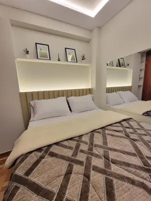 a bedroom with two beds and shelves on the wall at LUJO HOGAR - Cerca a Plaza Norte - UNI - Aeropuerto in Lima