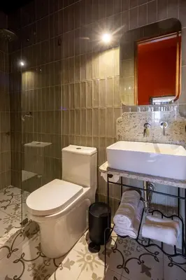 a bathroom with a toilet and a sink at Hotel 1821 in Cusco