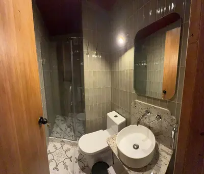 a bathroom with a toilet and a sink and a mirror at Hotel 1821 in Cusco