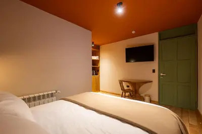 a bedroom with a bed and a tv on the wall at Hotel 1821 in Cusco