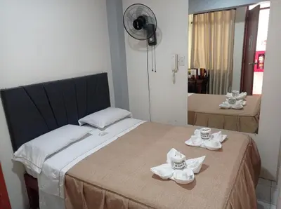 a hotel room with a bed with towels on it at Hs Corona in Lima
