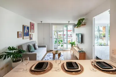 a living room with a table and a couch at Departamento en Barranco in Lima
