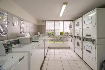 a laundry room with white appliances and a window at Departamento en Barranco in Lima