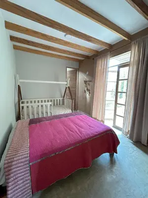 a bedroom with a large bed with a pink blanket at Casa de Campo con Piscina, BBQ y Naturaleza Cañete in Imperial