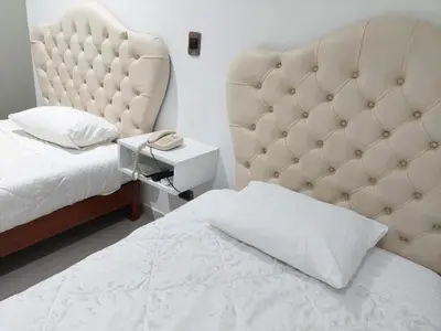 a bedroom with a bed and a large headboard at Miraflores Pacific Hotel in Lima