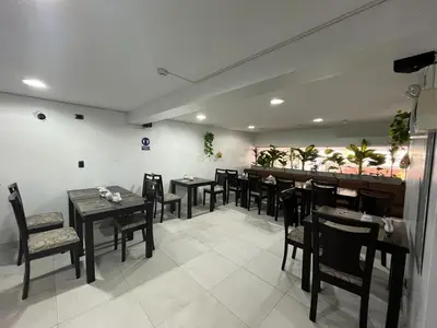 a dining room with tables and chairs in a restaurant at Miraflores Pacific Hotel in Lima