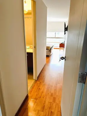 an open door to a room with a wooden floor at Departamento en Miraflores - Av Pardo Jose in Lima