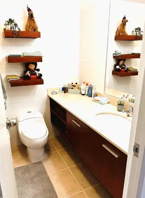 a bathroom with a toilet and a sink and a mirror at Departamento en Miraflores - Av Pardo Jose in Lima