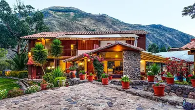 a house with potted plants in front of it at Casa en Calca in Calca