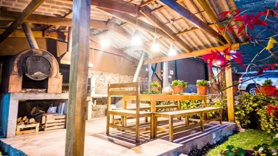 a patio with a table and chairs and a pizza oven at Casa en Calca in Calca