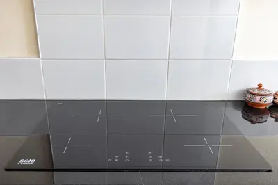 a tiled wall in a kitchen with a table at Intiflatscusco Comfortable Stay in the Heart of the City in Cusco