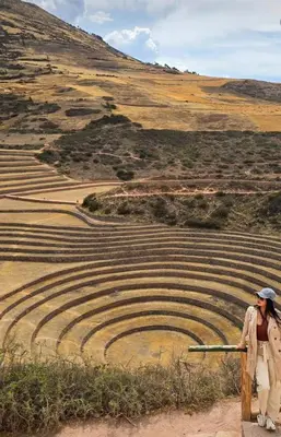 a man holding a gun looking at an amphitheater at Hotel Inka House Chinchero in Chinchero