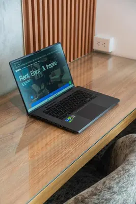 a laptop computer sitting on top of a wooden table at Ejército City Lofts & Apartments in Lima