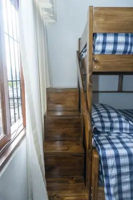 a staircase leading to a bunk bed in a room at Casa en el Medio de todo Estacion tren Angamos in Lima