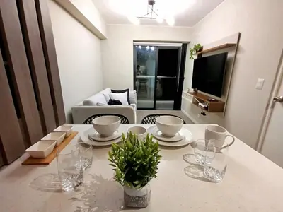 a dining room table with plates and glasses on it at Apartamento de ensueño in Lima