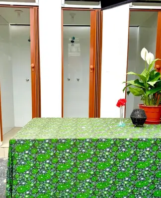 a green table with a green table cloth with flowers on it at Lima Hostel - Barranco in Lima