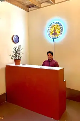 a man standing behind a counter with a sign at Lima Hostel - Barranco in Lima