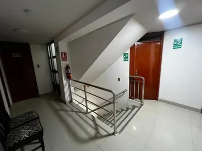 a hallway with a staircase in a building at Huamanga plaza in Ayacucho