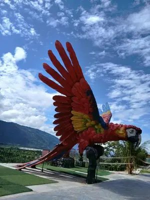 a large statue of a statue of a parrot at Recreo Hotel Aldea in Pichanaki