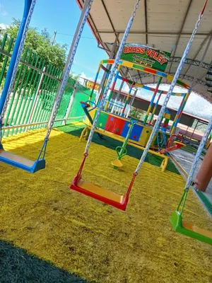 a swing set withswingoons and a playground at Recreo Hotel Aldea in Pichanaki