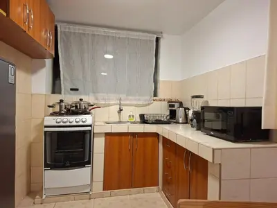 a small kitchen with a stove and a microwave at Cusco Hermoso in Cusco