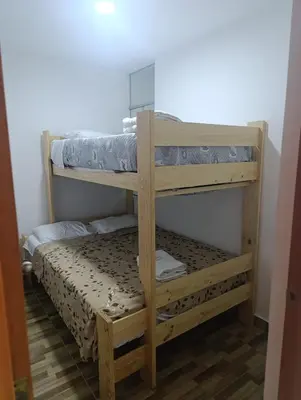 a couple of bunk beds in a room at Departamento Frente al Cc Mega plaza - Ica in Ica