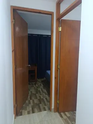 an open door to a room with a bed at Departamento Frente al Cc Mega plaza - Ica in Ica
