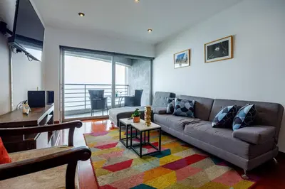a living room with a couch and a table at BSR Oceanview Family Flat w/ Parking in Lima