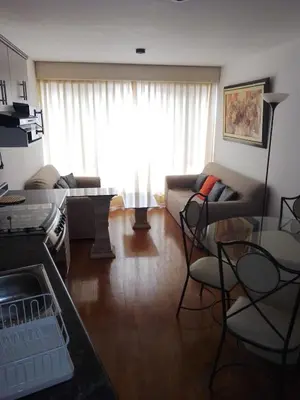a living room with a couch and a table at Miraflores, Lima, apartamento 2 dormitorios in Lima