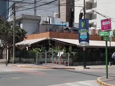 a building on a city street with a sign at Miraflores, Lima, apartamento 2 dormitorios in Lima