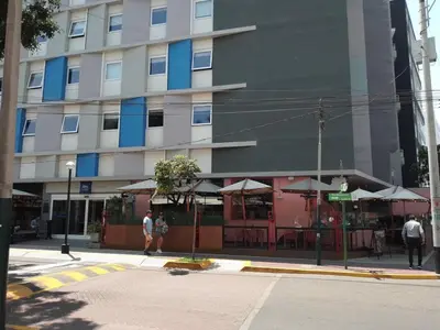 a building on a street with people walking in front of it at Miraflores, Lima, apartamento 2 dormitorios in Lima