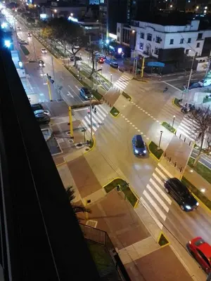 a city street at night with cars on the road at Miraflores, Lima, mini apartamento 2 ambientes in Lima