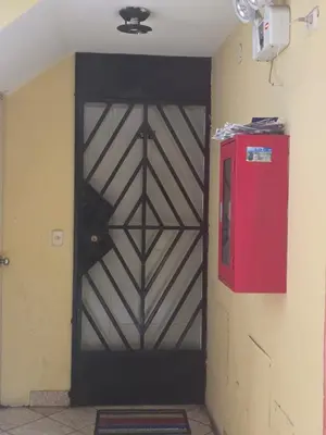 a black door in a room with a red box at RODRICH apartment 2 in Lima
