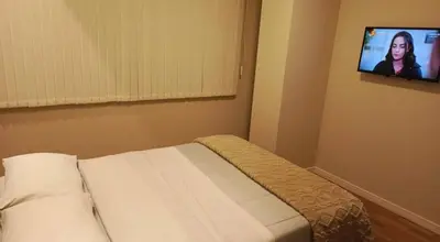 a bedroom with a bed and a tv on the wall at Posada del inka in Cusco