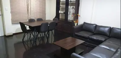 a living room with a couch and a table at Los Tambos Apartment in Cusco
