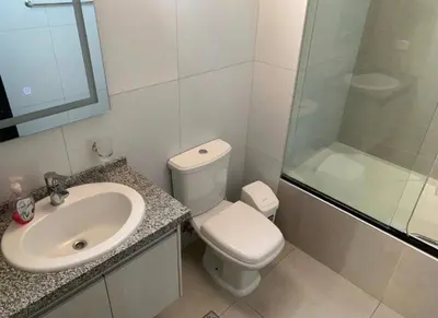 a bathroom with a toilet and a sink and a shower at Los Tambos Apartment in Cusco