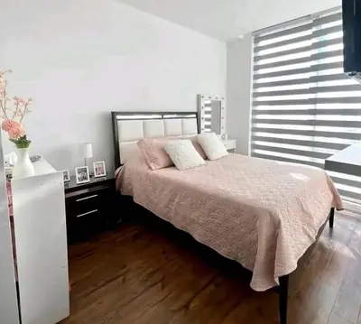 a bedroom with a bed and a dresser and a window at La Panaca Del Inka Apartment in Cusco