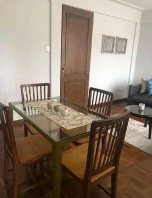 a dining room with a glass table and chairs at Inka Garden Apartment Cusco in Cusco