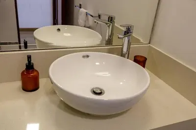 a white sink in a bathroom with a mirror at BSR Romantic Escape Flat w/ Rooftop Pool in Lima