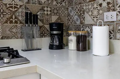 a kitchen counter with a coffee maker on a counter top at BSR Romantic Escape Flat w/ Rooftop Pool in Lima