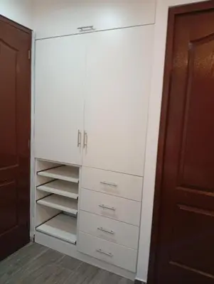 a closet with white cabinets and drawers at Si buscas un lugar para tu familia in Cusco