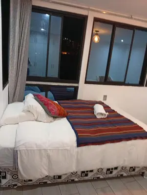 a large bed in a room with a window at Si buscas un lugar para tu familia in Cusco