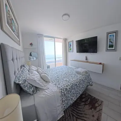 a bedroom with a bed with a view of the ocean at Ocean Blue, Vista Frontal Al Mar in Lima