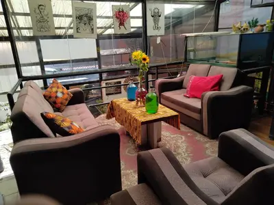 a living room with two couches and a coffee table at SOLGARDENs in Cusco