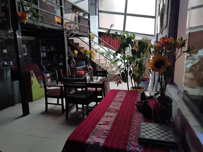 a room with a table with flowers on it at SOLGARDENs in Cusco