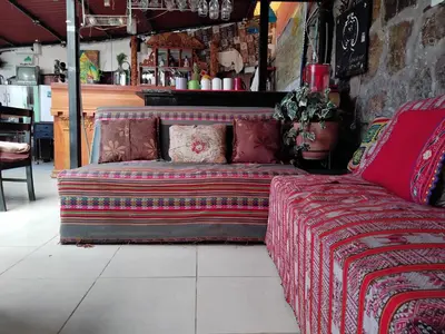 a couch sitting in a room in a store at SOLGARDENs in Cusco