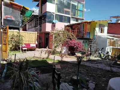 a group of buildings with plants in a yard at SOLGARDENs in Cusco