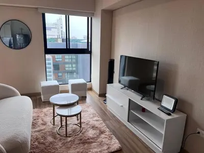 a living room with a flat screen tv and a couch at APARTMENT NEW COMFORTABLE in MIRAFLORES in Lima