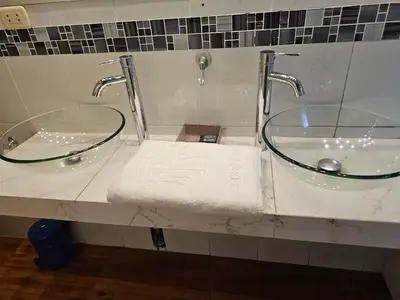 a bathroom with two mirrors and a sink at CasaHotel Chaclacayo in Chaclacayo
